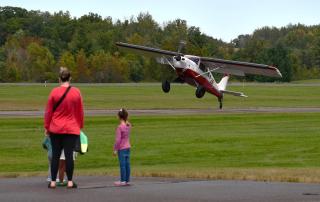 People gathered beside aircraft at the annual Mora Fly-In