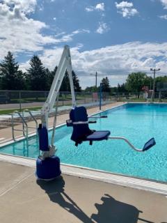 Accessible pool lift beside the Mora Aquatic Center pool